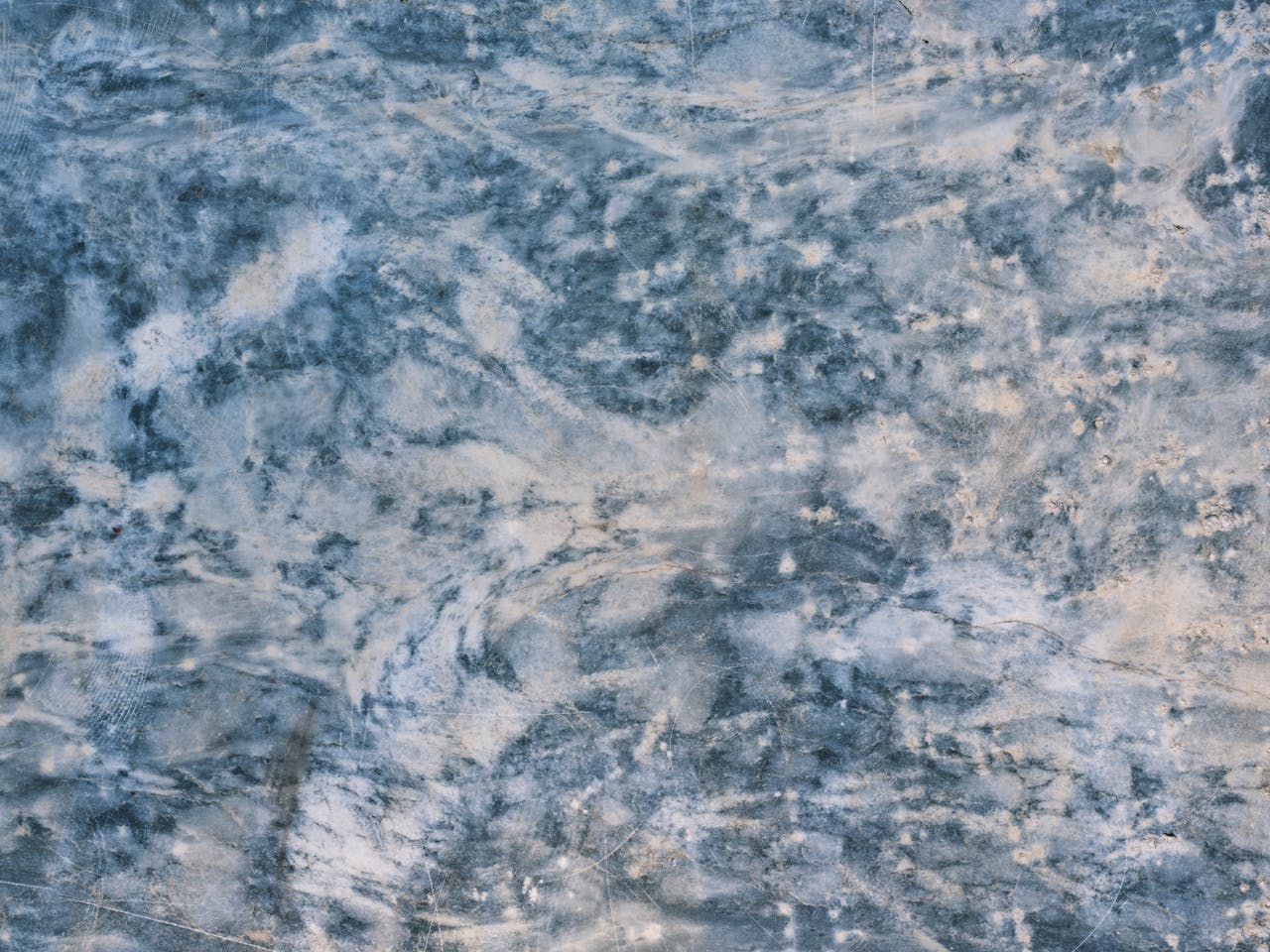 Close-up view of a blue and white marble surface texture, ideal for backgrounds.