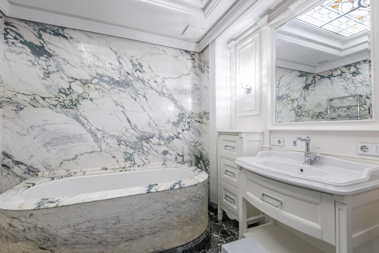 Elegant bathroom with marble walls and modern fixtures creating a luxurious at-home experience.