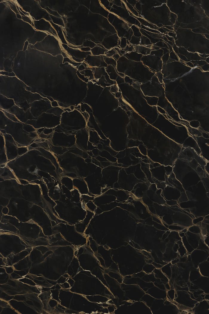 High-quality image of a dark marble texture with intricate patterns, perfect for backgrounds or designs.